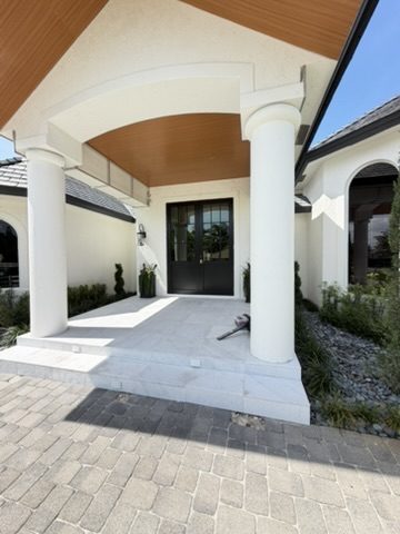 Impact French entry doors under a covered front porch in South Florida